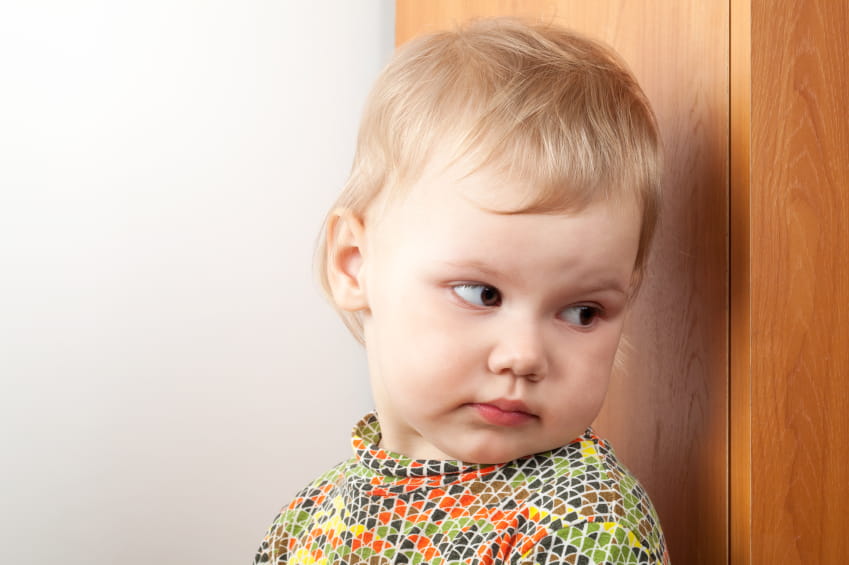 child eyeing cabinet