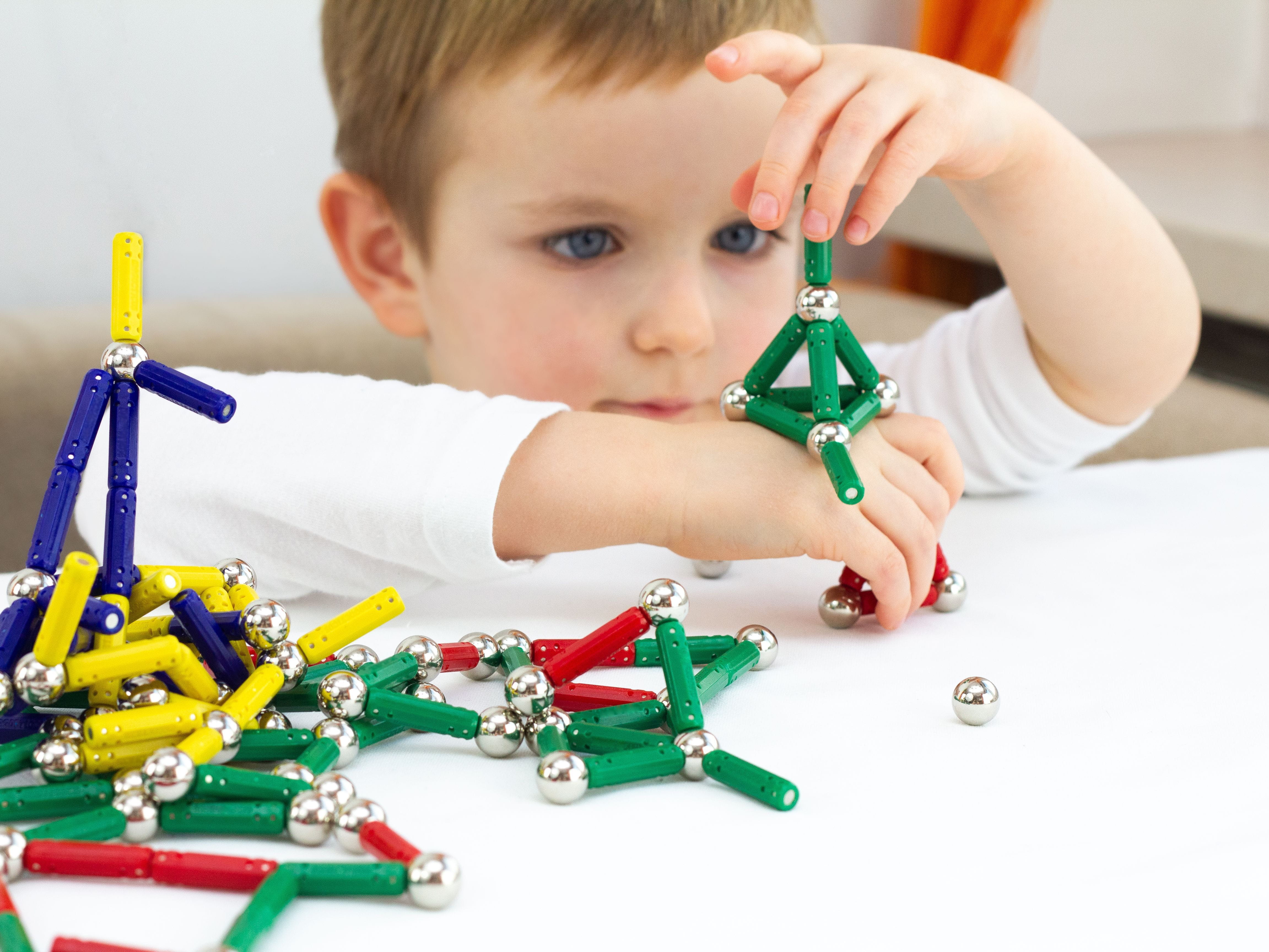 kid playing with magnets
