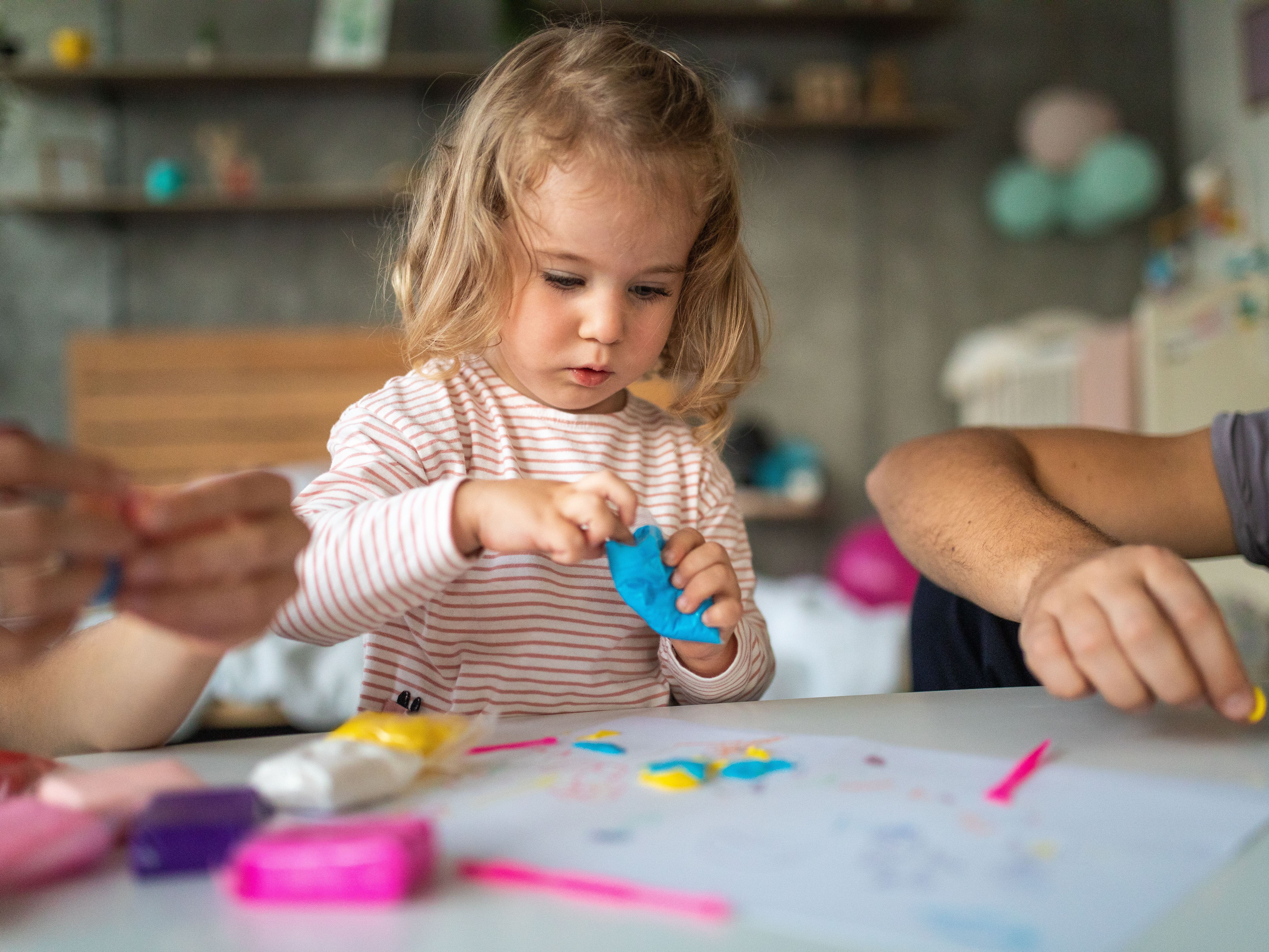 little girl playing with play-doh