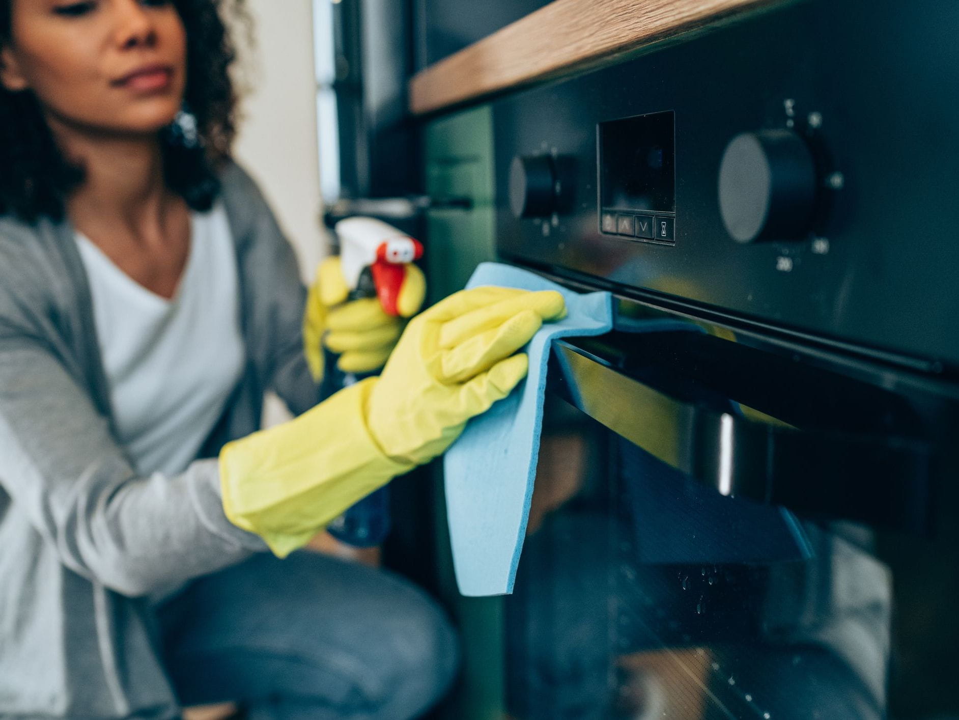 woman spraying oven