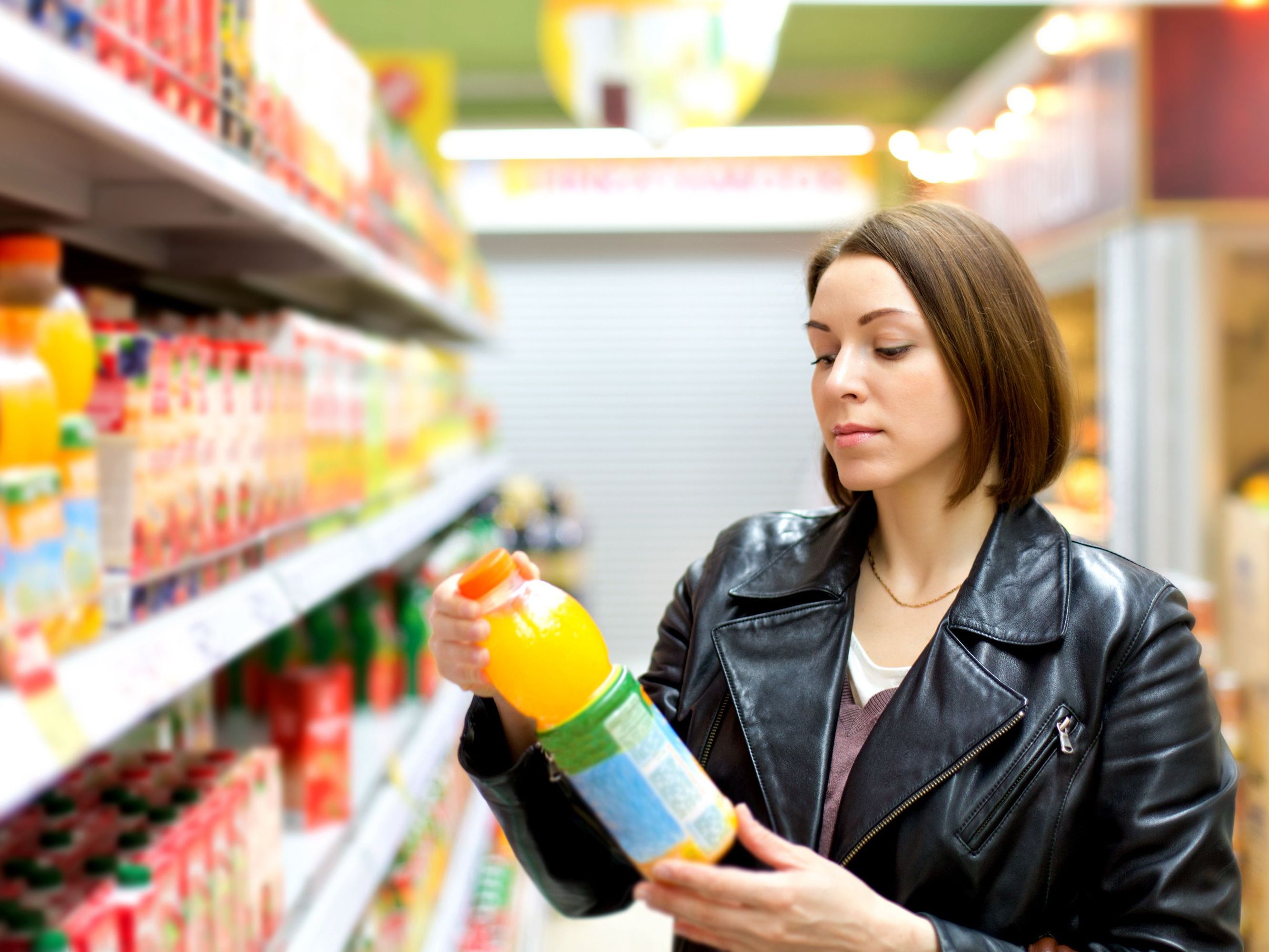 woman examining drink at store