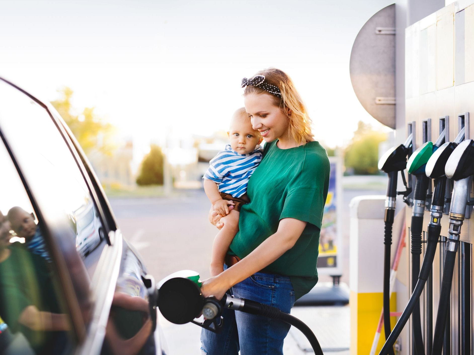 mother filling car with gas