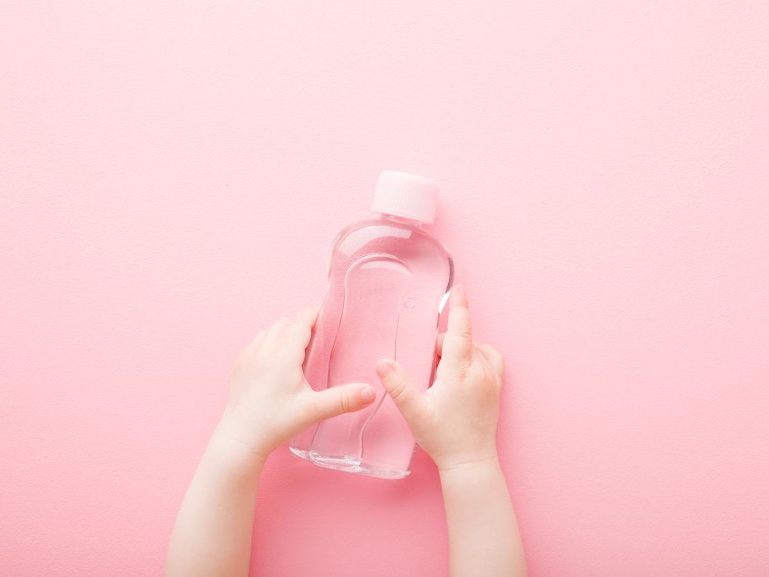 baby oil against pink background