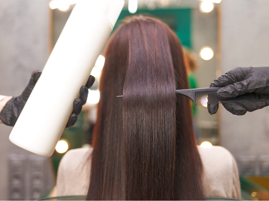 woman at a salon with chemically straightened hair
