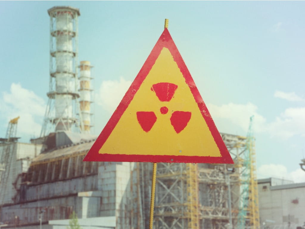 Photo of a radiation sign in front of Chernobyl nuclear power plant