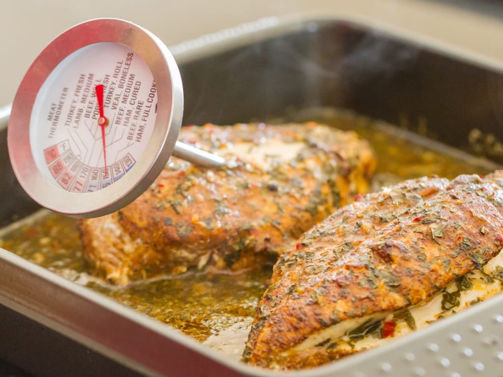 cooked chicken with a meat thermometer