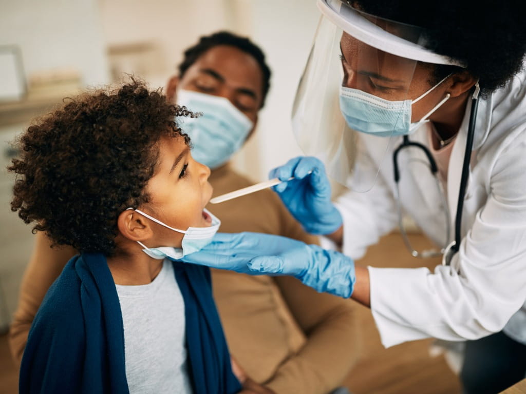 doctor examining a child's throat