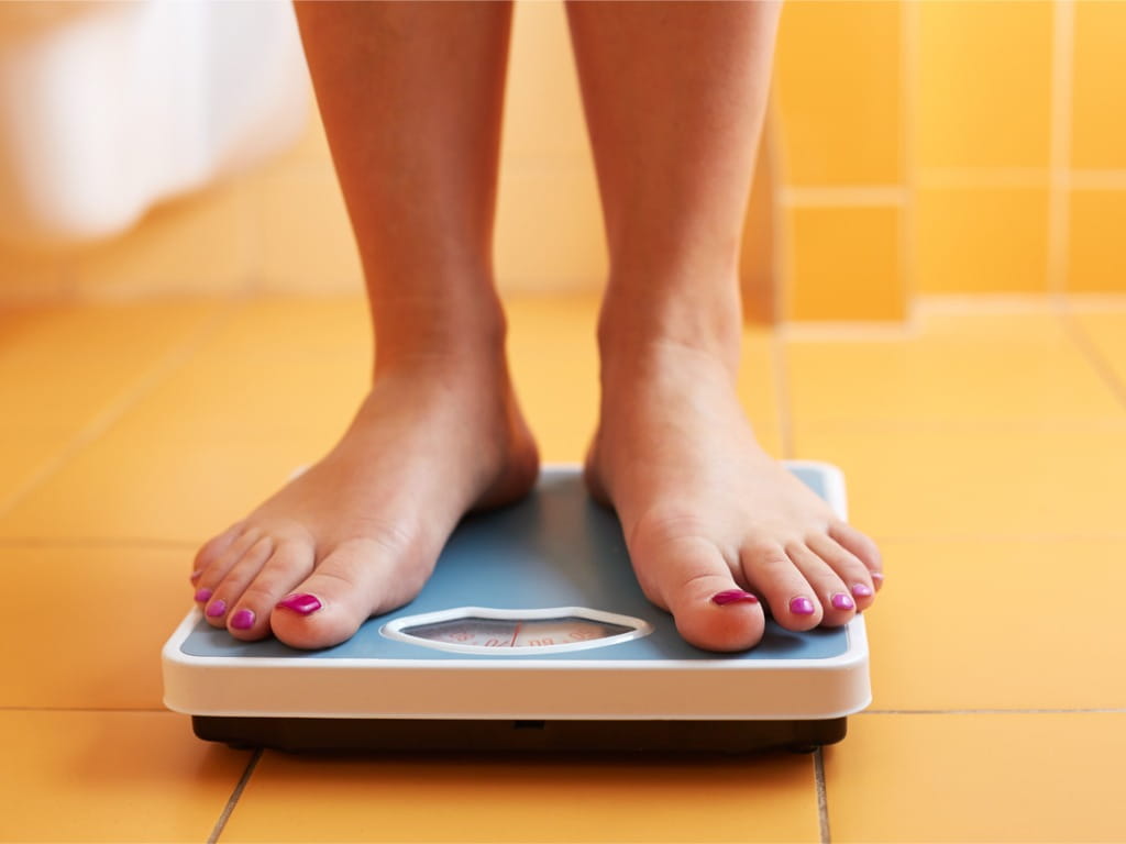 feet on a bathroom scale