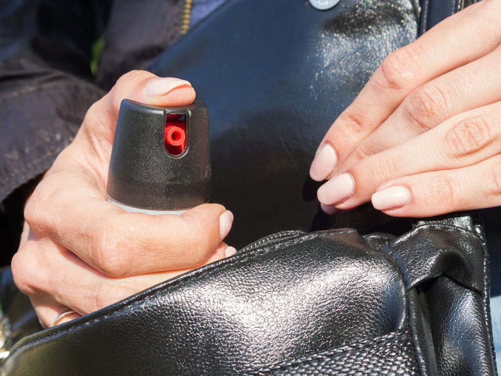 woman pulling pepper spray out of her purse