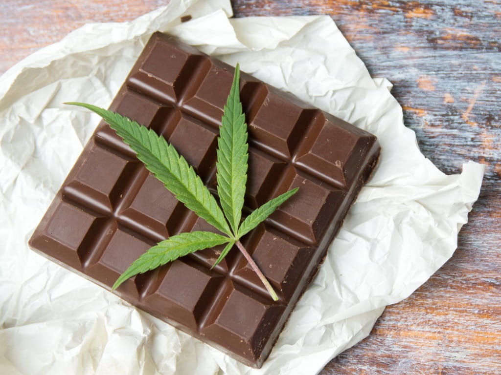 marijuana leaf on top of cannabis chocolate bar