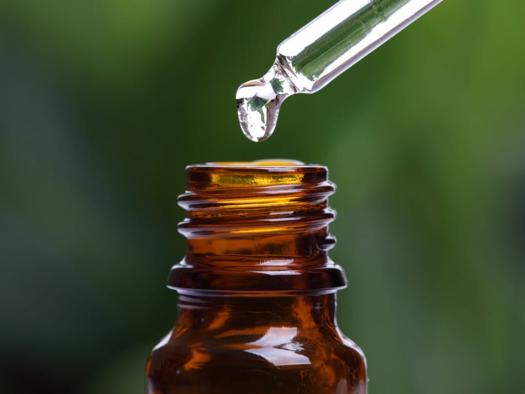 medicine dropper over amber bottle