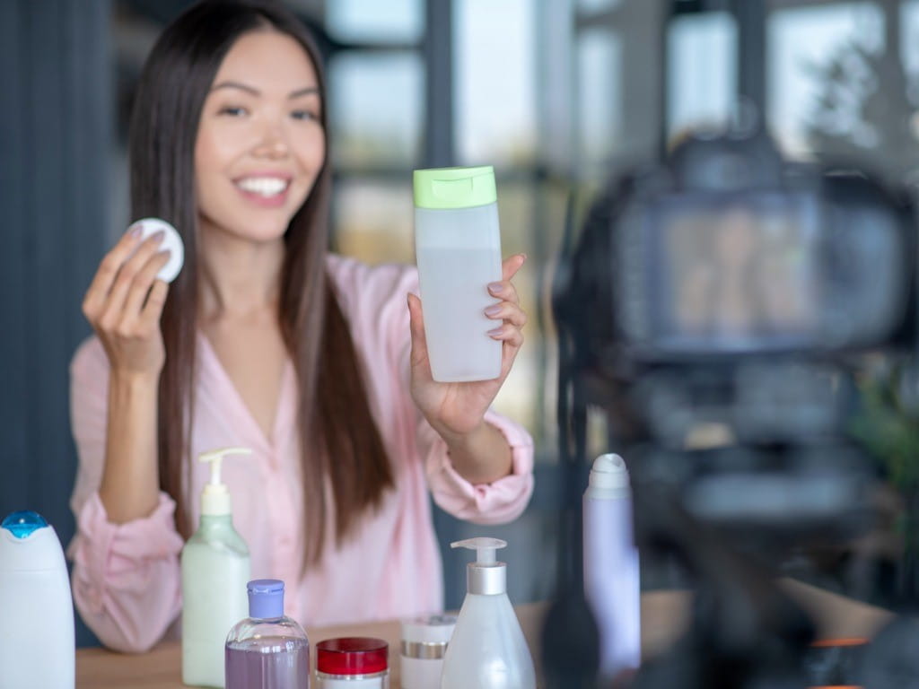 woman showing a bottle of micellar water