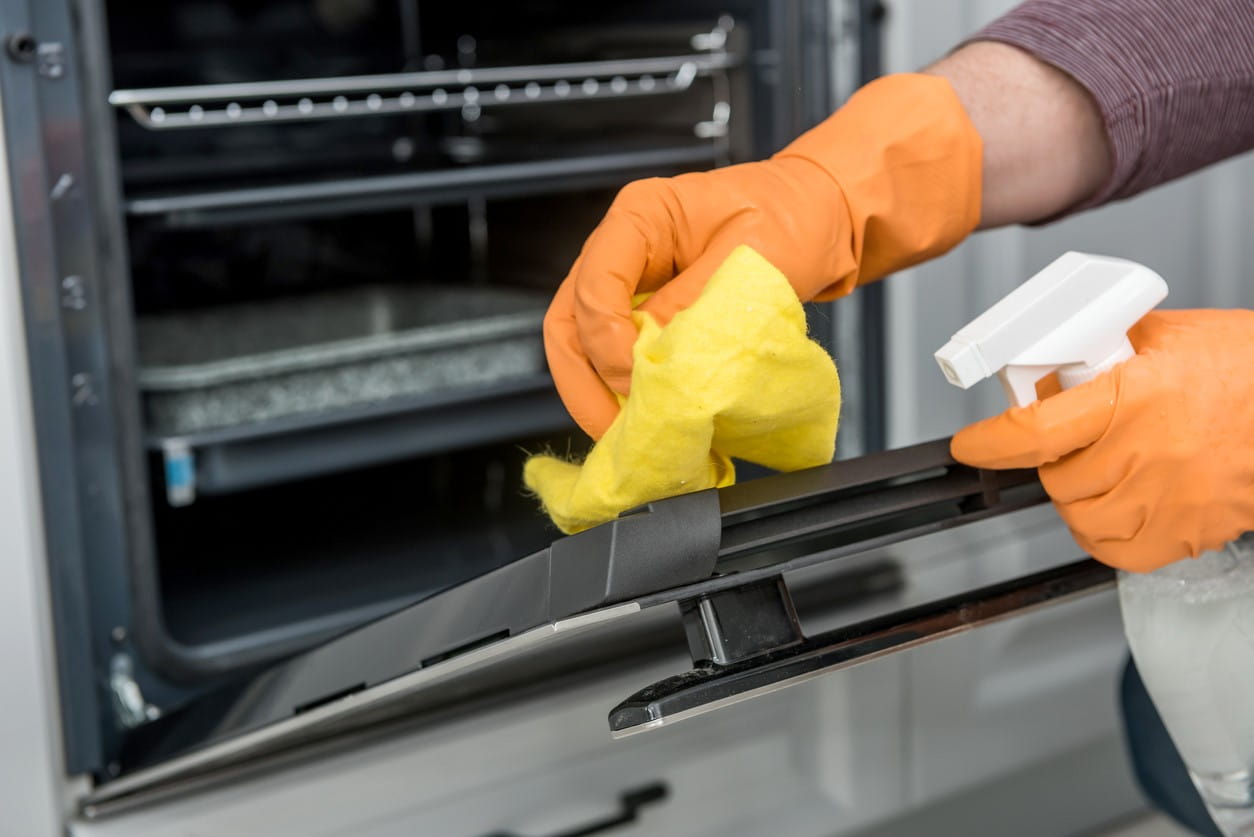 oven cleaners hands cleaning oven