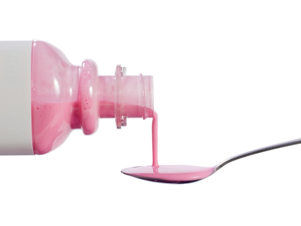 pepto bismol poured into spoon