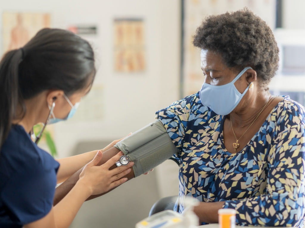 perindropil nurse taking older woman's blood pressure