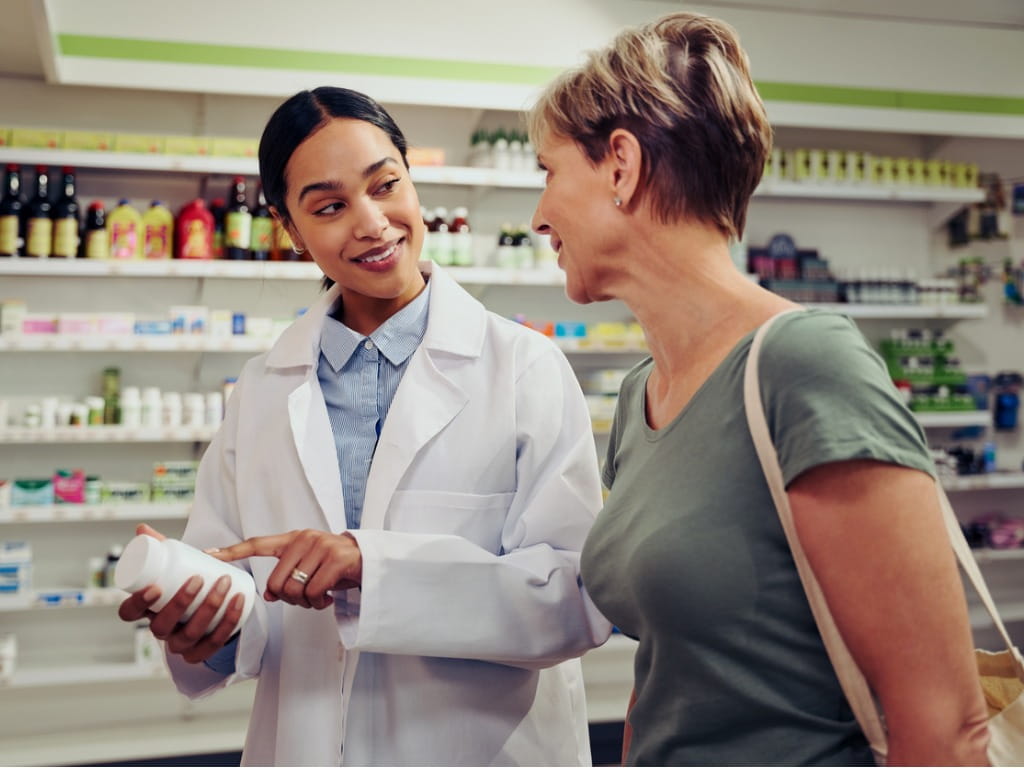 pharmacist discussing medicine with patient