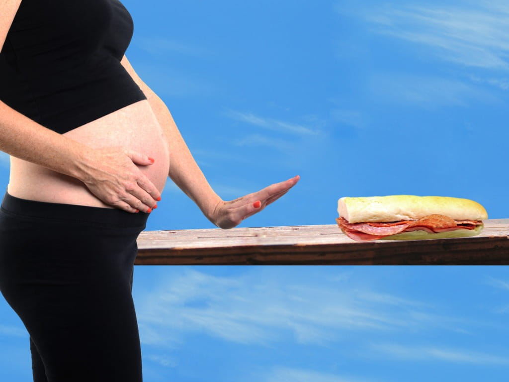 pregnant woman rejecting deli meat