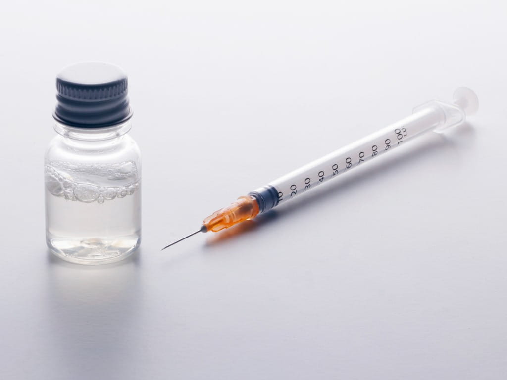 syringe and mystery vial on white