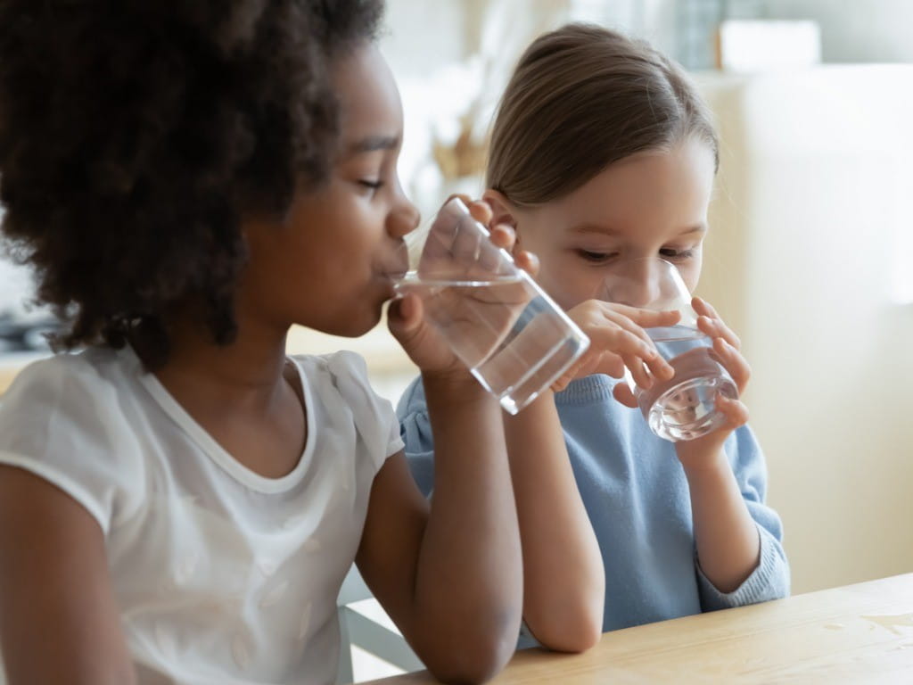 well water two girls drinking water