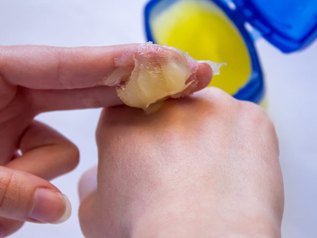 woman applying vaseline to her hand