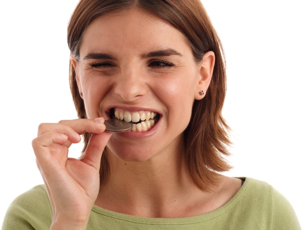 woman biting coin