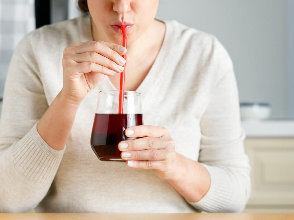 woman drinking cherry juice