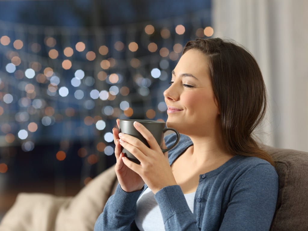 woman drinking coffee from a mug