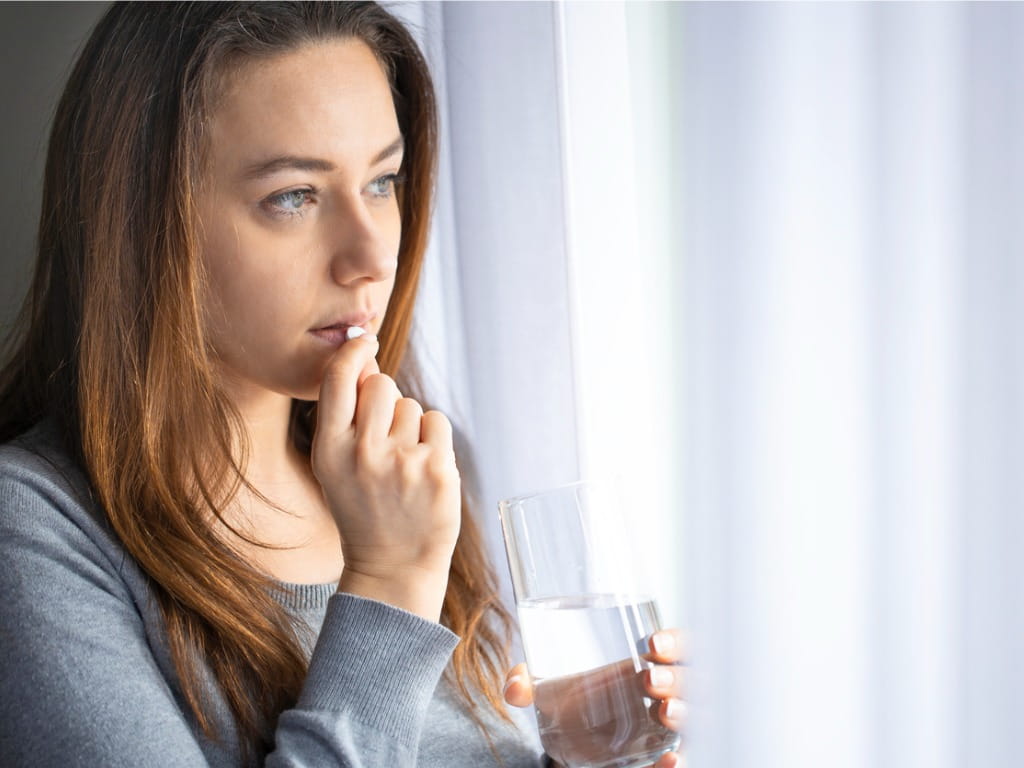 woman taking a Prozac pill