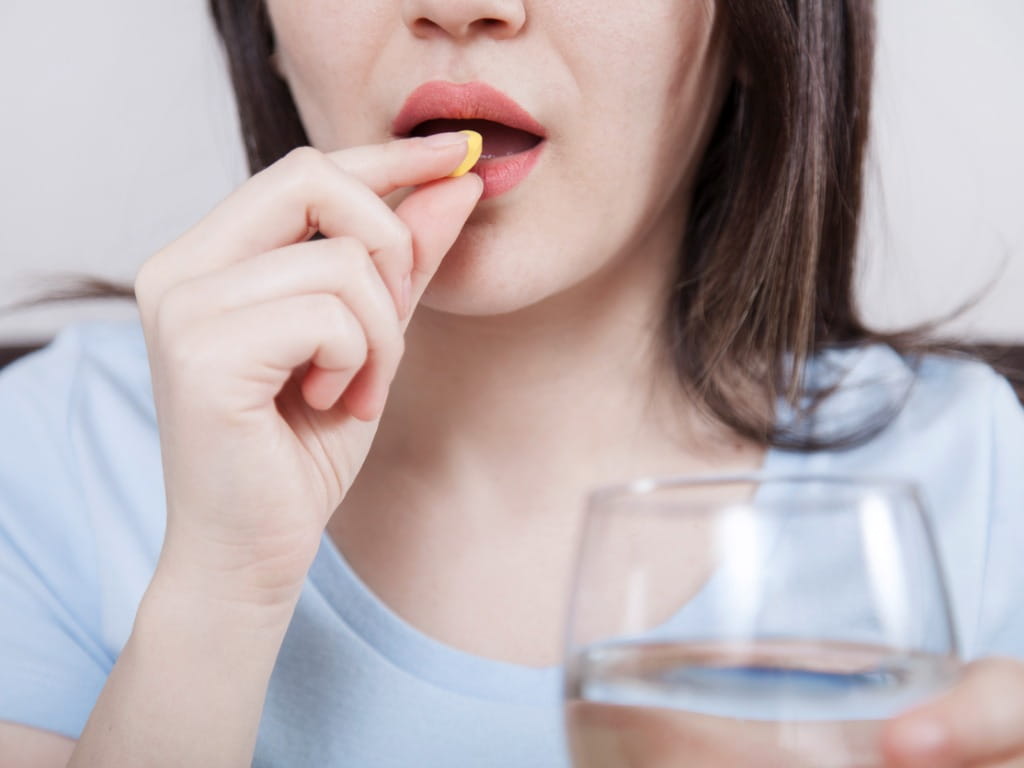 woman taking a pill