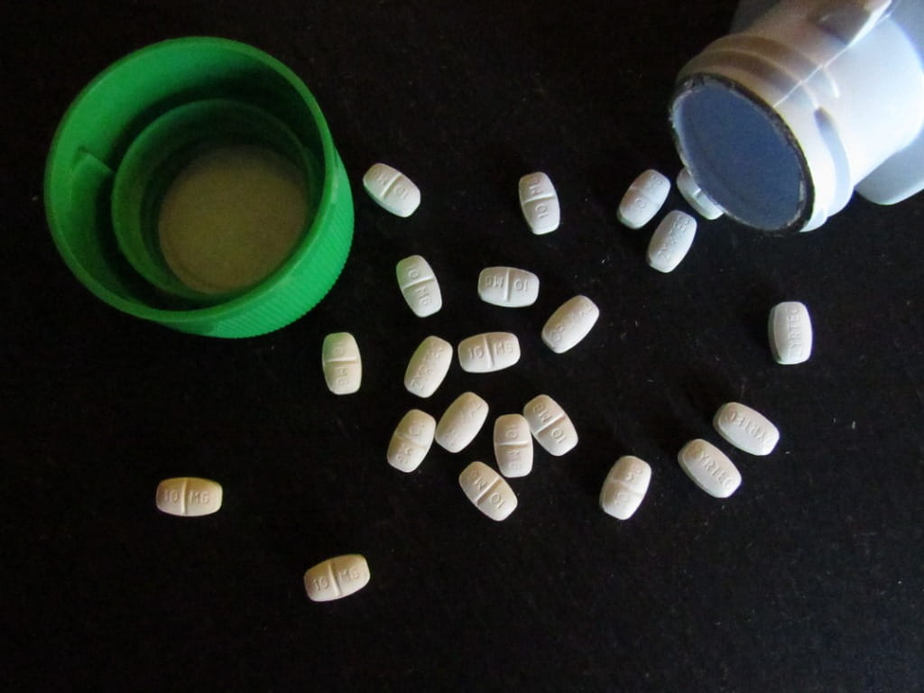 Zyrtec pills on a black table