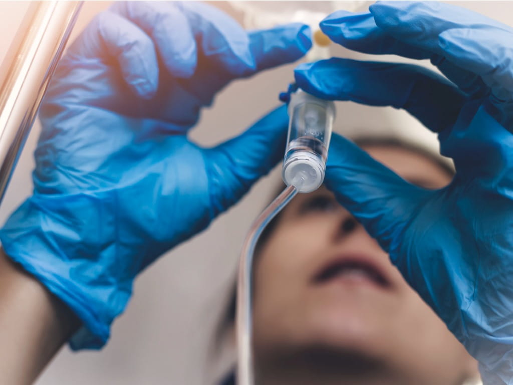 Nurse adjusting an IV